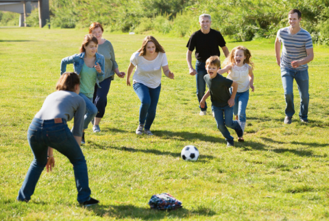 Family playing soccer