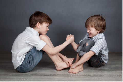 two boys arm wrestling