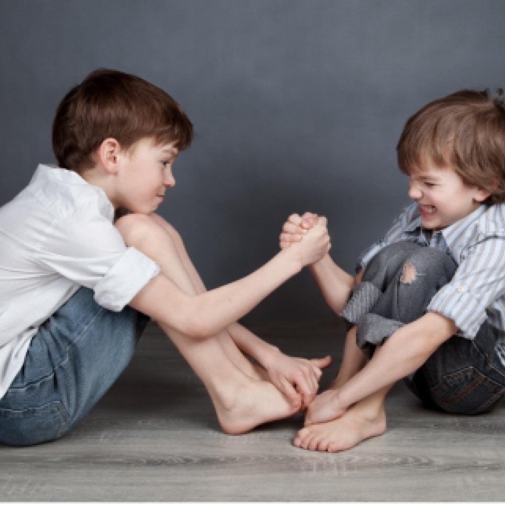 two boys arm wrestling